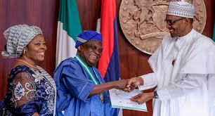 * Prof Obafemi receiving NNOM from President Buhari